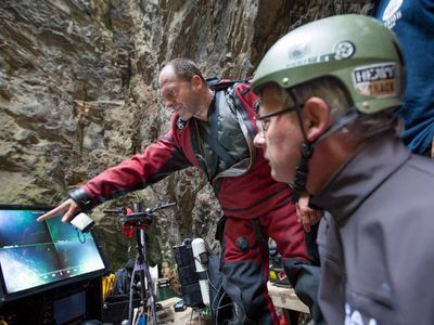 Polish explorers check a footage from a remote-operated vehicle deep in the Czech Republic's deepest cave.