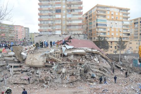 Rescue workers and volunteers conduct search and rescue operations in the rubble of a collasped building in Diyarbakir, Turkey.&nbsp;