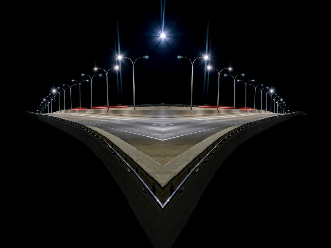 An altered reflection image of a Bridge at night. | Smithsonian Photo ...