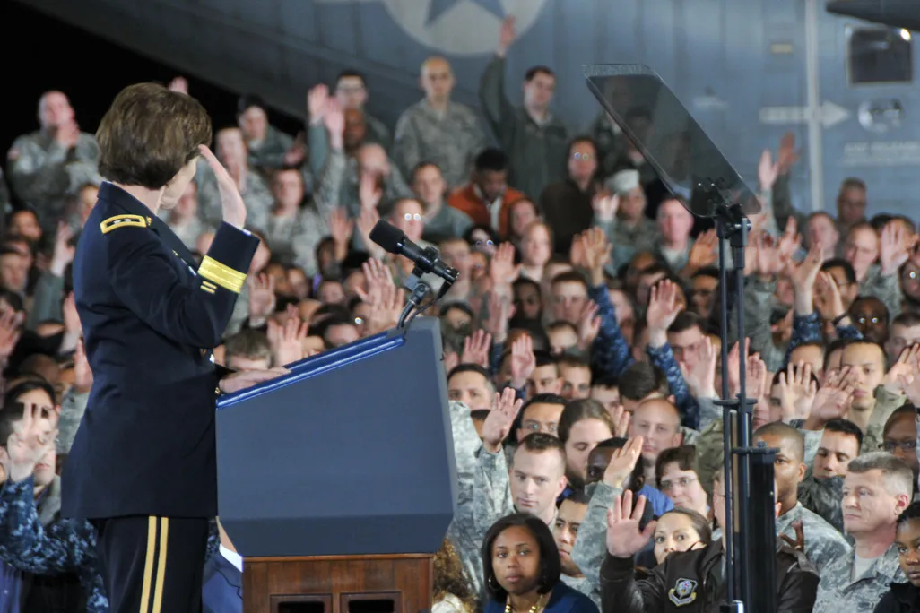 Army Reserve members raise hands