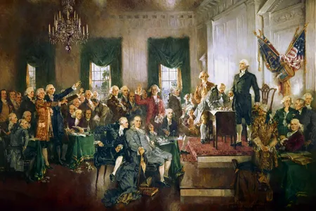 "Scene at the Signing of the Constitution of the United States" by Howard Chandler Christy. James Madison is at center, seated, to the right of Ben Franklin.