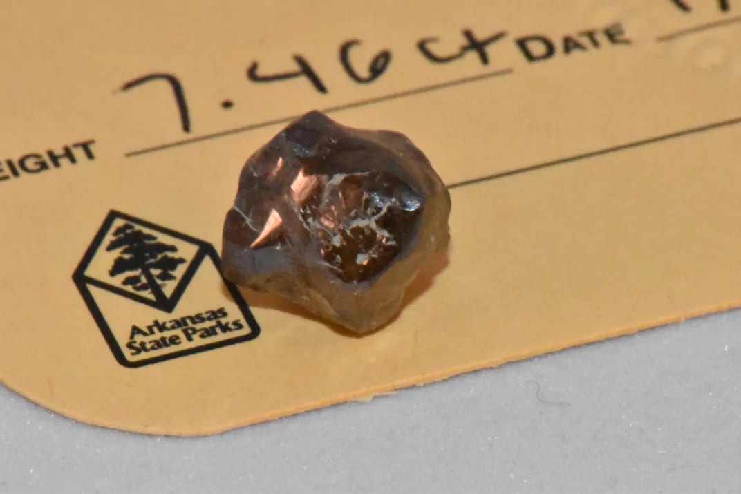 Brown diamond sitting on a piece of paper