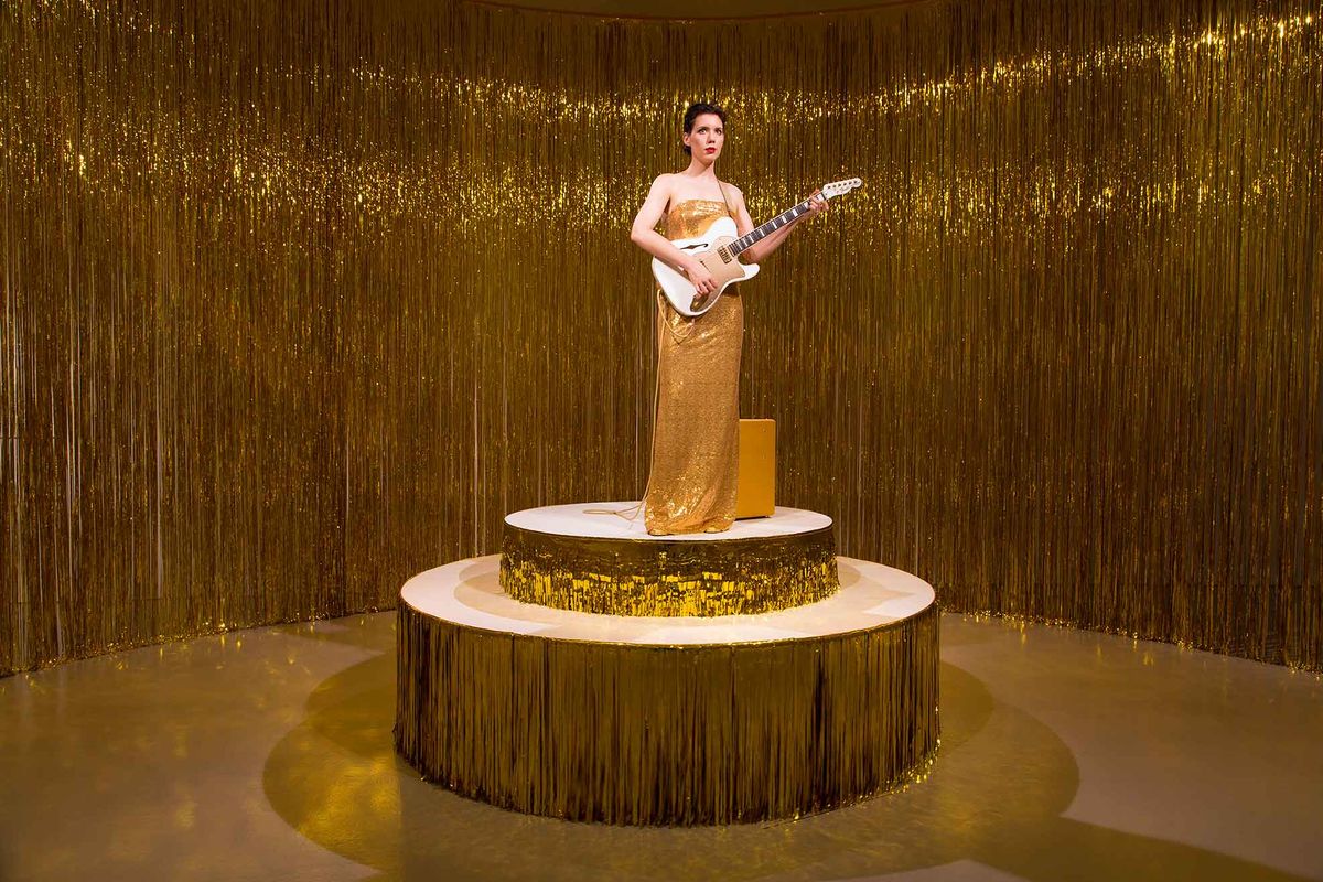Why a Woman Is Playing the Same Guitar Chord Over and Over Again