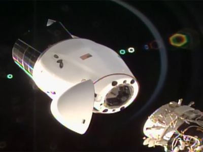 The SpaceX Cargo Dragon capsule separating from the International Space Station after undocking from the Harmony module’s international docking adapter. 
