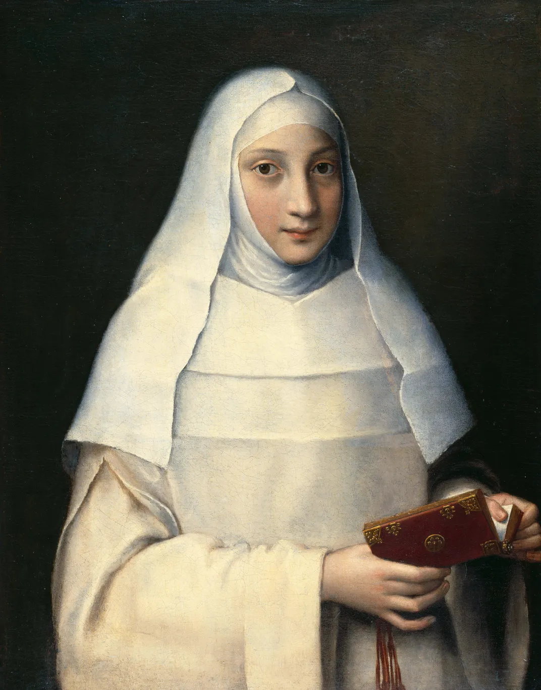 A portrait of a woman in pale white garbs, making eye contact with the viewer and holding a book open in her hands