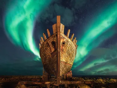 An old Viking ship under the Northern Lights in Iceland