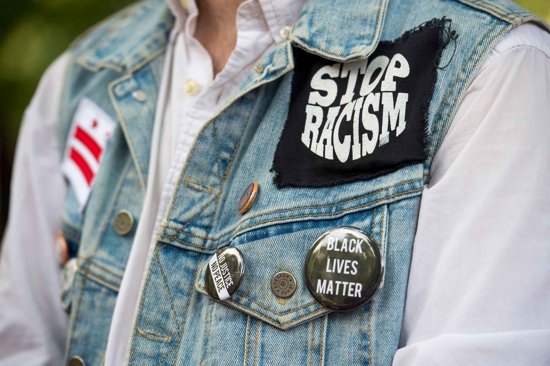 woman wearing Black Lives Matter button