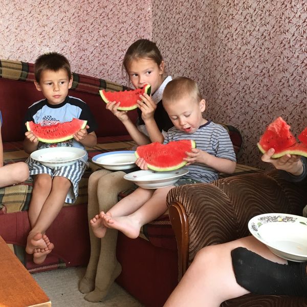 Children eating watermelon in rural Russia in September thumbnail