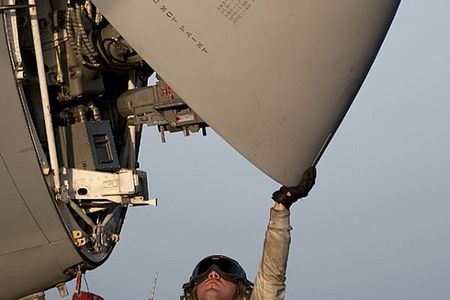 An Aviation Electronics Technician inspects the radar of an EA-6B Prowler, presumably to address that pesky humming sound.