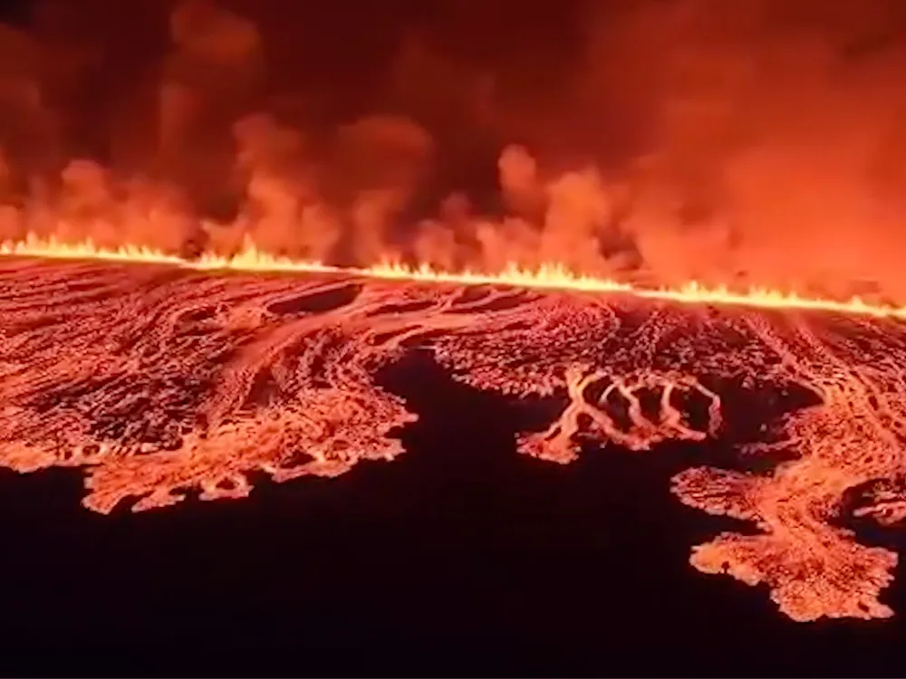 lava erupting and flowing from a long fissure