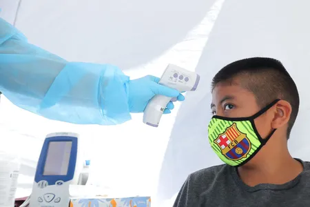 A boy has his temperature checked as he receives a free COVID-19 test in Los Angeles.