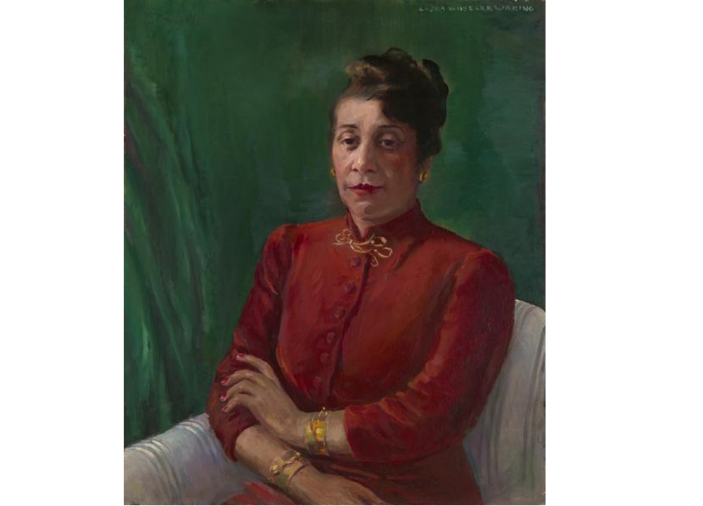 Distinguished in a high-collared, red shirt and gold jewelry, Alma Thomas wears her hair up and looks directly at the viewer. Her arms are crossed loosely, and she sits before a green background.
