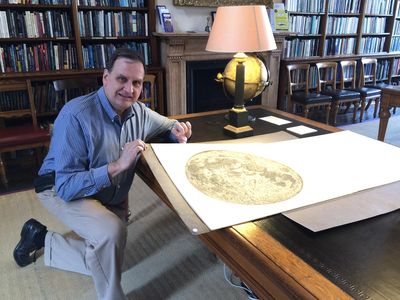 The author in the library of the Royal Astronomical Society in London with Cassini’s 1679 map of the Moon.