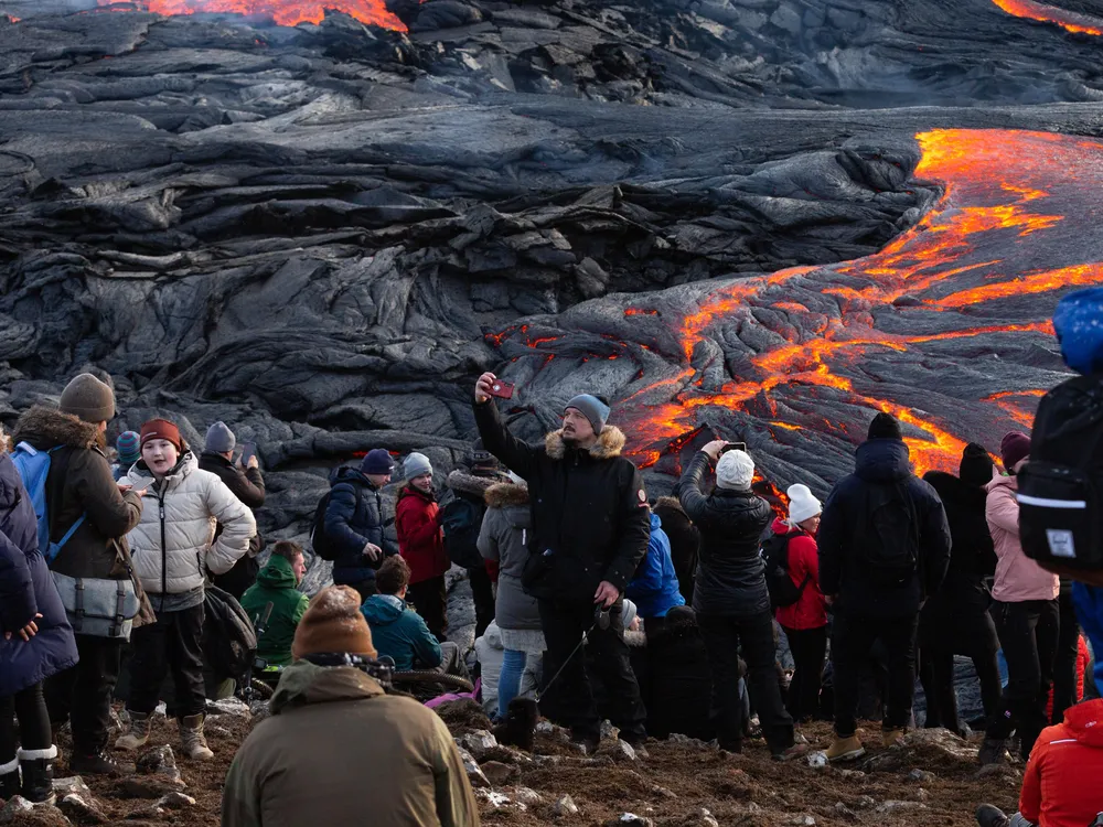 A man take a selfies in front of the lava field on March 28, 2021 on the Reykjanes Peninsula, Iceland