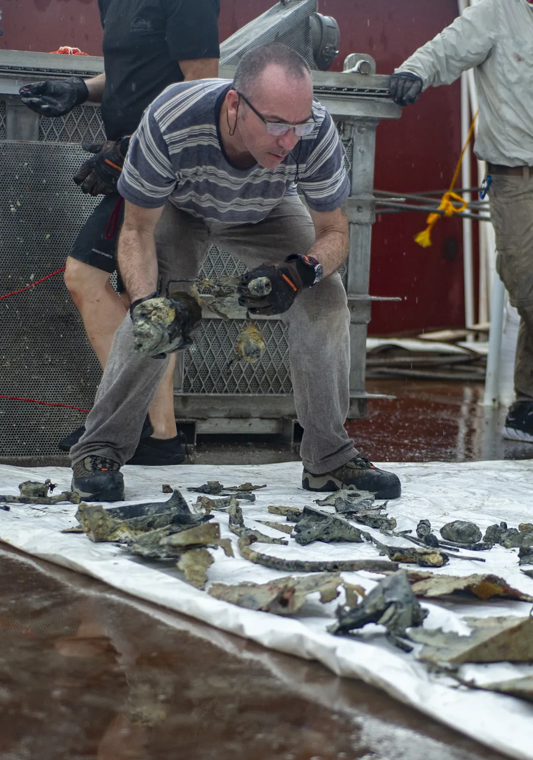 Archaeologist Anthony Burgess examines parts of the wreck.