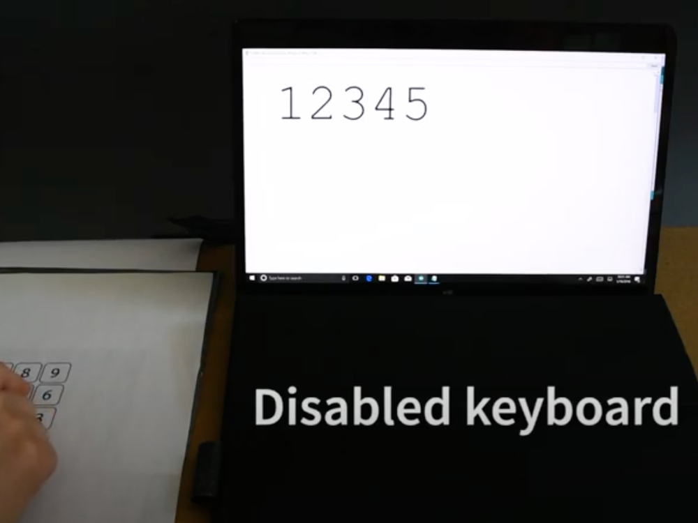 Paper keypad next to laptop