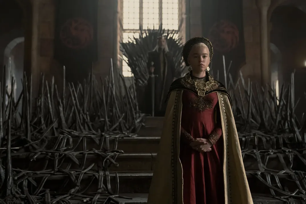Paddy Considine as Viserys (background) and Milly Alcock as Rhaenyra (foreground) in HBO's “House of the Dragon”