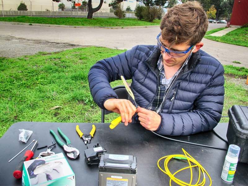 Nate Lindsey trims cable at the Richmond Field Station