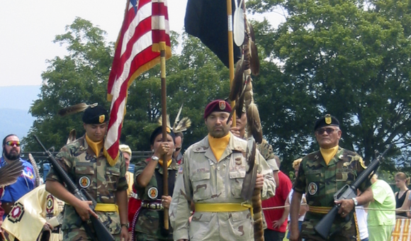 On mid-tour leave from Operation Iraqi Freedom, Sergeant First Class Chuck Boers carries in the eagle staff at the Shenandoah Powwow, 2004. (Courtesy of Chuck Boers)