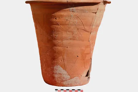 The chamber pot stands about 12.5 inches tall and measures 13.5 inches wide at the rim.