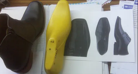 A sample elevator boot, graphic models, and the last on which it was made