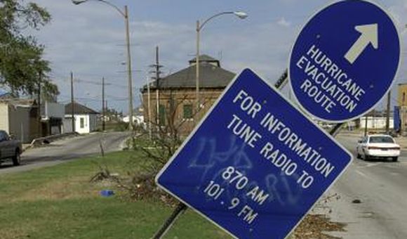 Sign marking an evacuation route, tilted by the storm. Photograph by Hugh Talman.