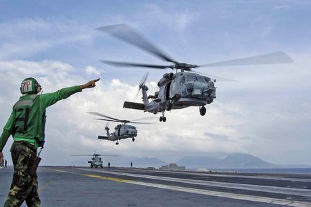 Taking off from the deck of the USS Abraham Lincoln as part of Operation Unified Assistance, Seahawks respond to the tsunami that hit Indonesia in December 2004.