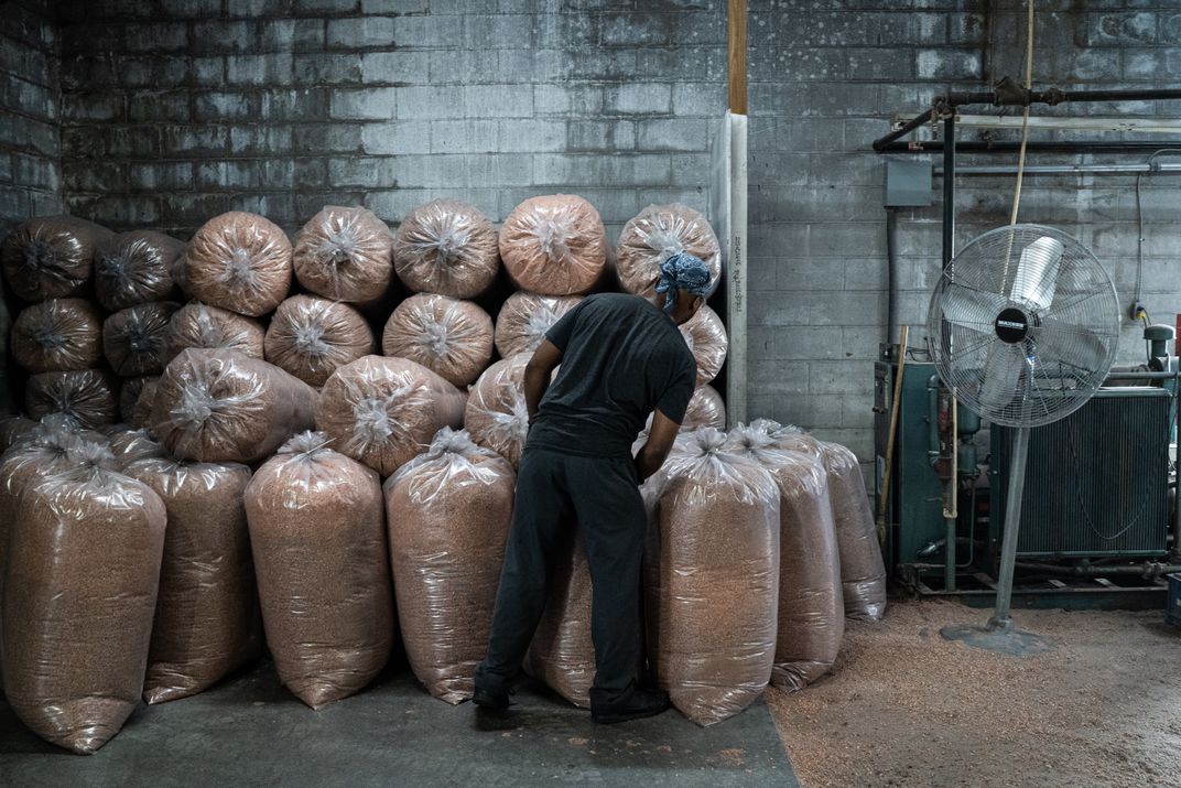 a man sorts bags of sawdust