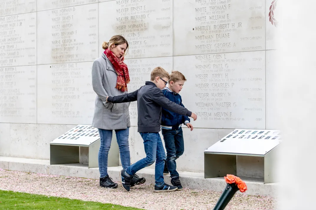 A family at the Walls of the Missing at the Netherlands American Cemetery