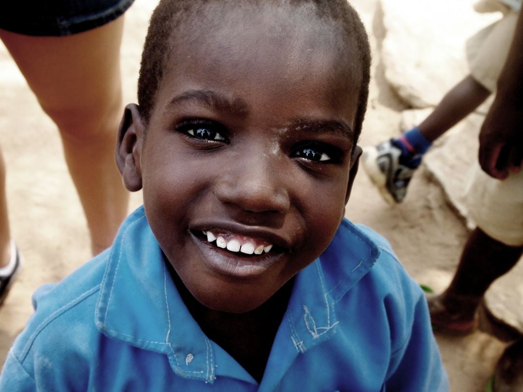 Excited school child during recess in rural African village ...