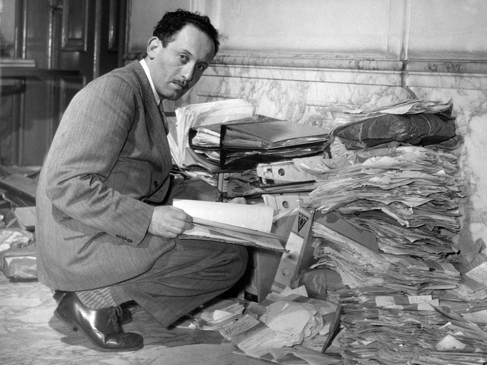 Louis de Jong, founder of NIOD examining documents on the Holocaust post-war, © Nationaal Archief Collection Spaarnestad Photo.jpg