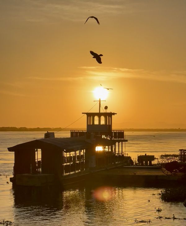 Boat, birds and sunrise on the river. thumbnail