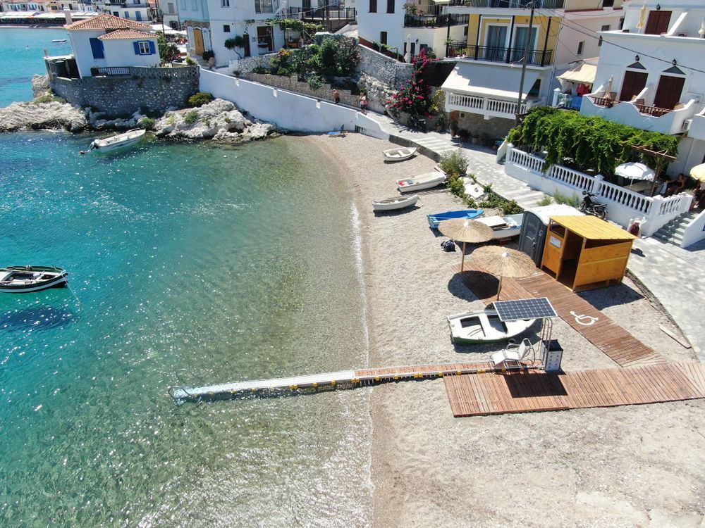 Blue water next to beach with wheelchair ramp