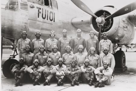 Men of the all-African American 477th Bombardment Group pose in front of a North American B-25 Mitchell.