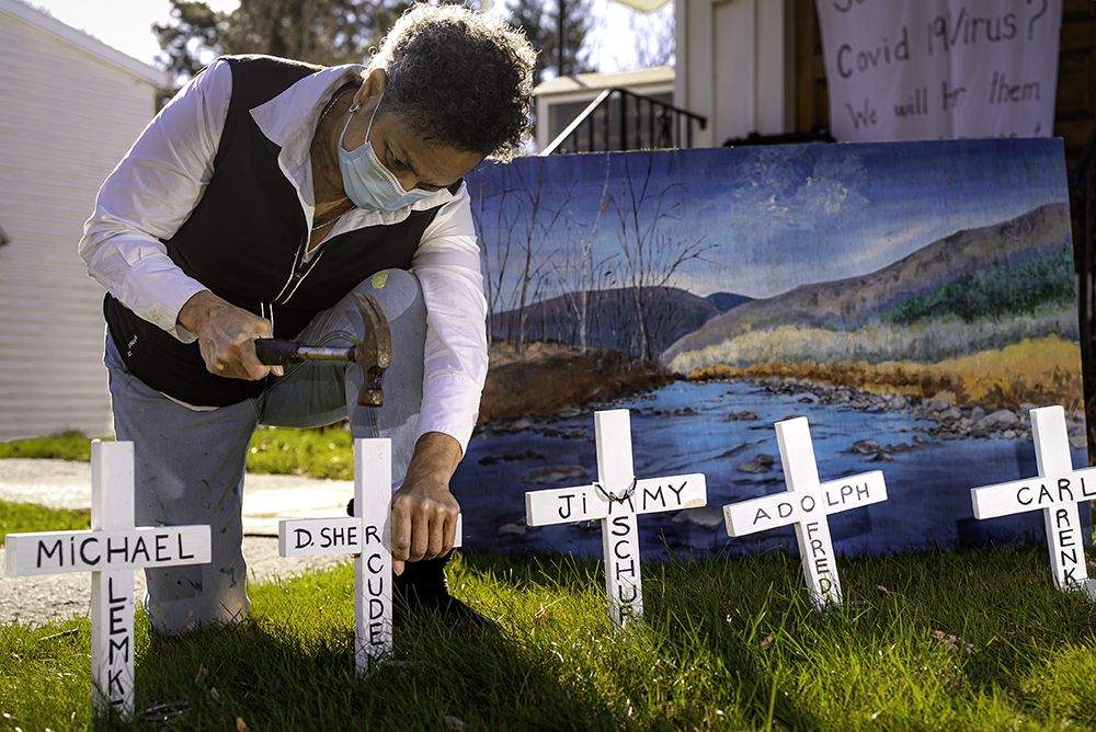 Julia Santos Solomon inserting crosses for her In Memoriam installation, Christ Lutheran Church, Woodstock, NY, 2020. Photo by Scott Barfield.