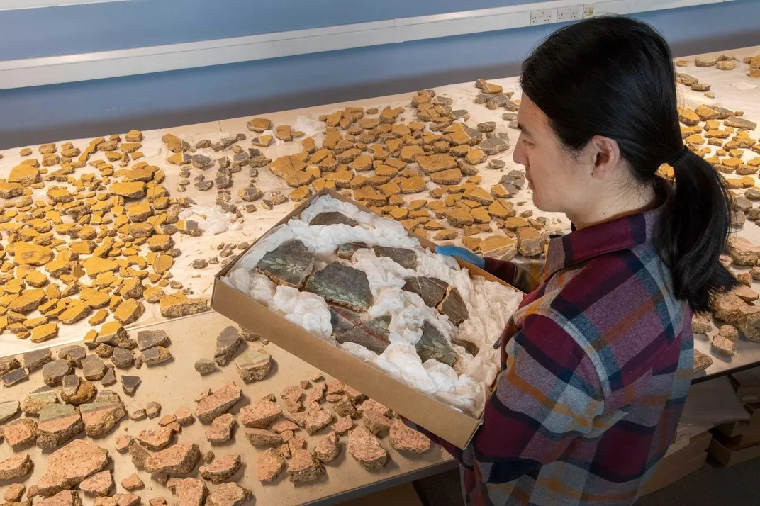 mola_specialist_han_li_reconstructing_the_wall_plaster_mola_museum_of_london_archaeology_1.jpg