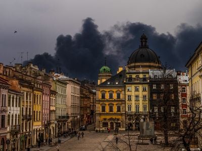 After an attack by Russian forces in late March, smoke rises from an oil depot not far from Rynok Square in Lviv in western Ukraine