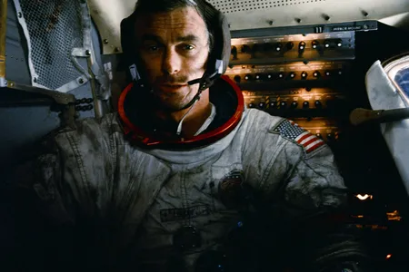 Apollo 17 mission commander Eugene Cernan inside the lunar module on the moon after his second moonwalk of the mission. His spacesuit is covered with lunar dust.