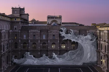 Dilivium, a sculpture by the French artist JR, spans roughly 230 feet across the Vatican Apostolic Library&rsquo;s facade.&nbsp;