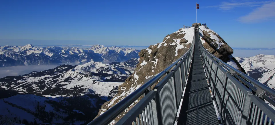  Hiker's suspension bridge spanning Alpine ridges 