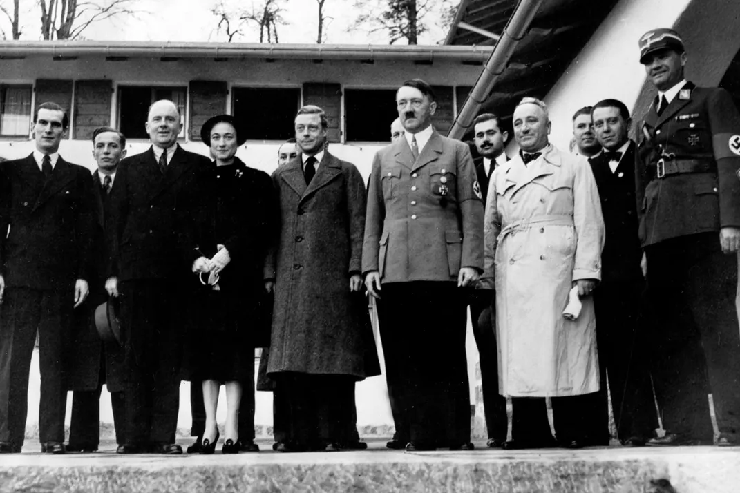 Wallis and Edward (fourth and fifth from left) pose alongside Adolf Hitler at the German dictator's country house in October 1937.