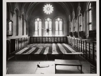 A 1914 photo of the Star-Spangled Banner undergoing conservation in the Smithsonian Castle