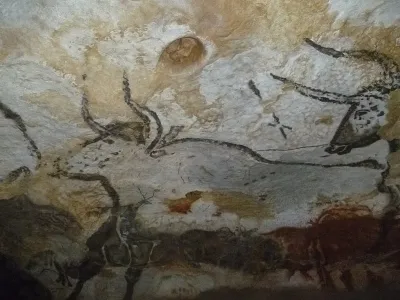 A cave painting of an extinct cattle species from Lascaux, France, with markings on its back.
