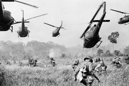 U.S. Army helicopters pour machine-gun fire into the tree line to cover the advance of South Vietnamese ground troops as they attack a Viet Cong camp 18 miles north of Tay Ninh, near the Cambodian border, in March 1965.