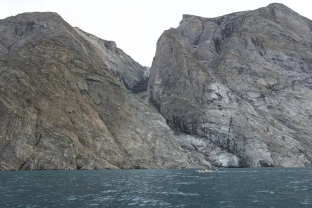 A mountain in the Dickson Fjord after 33 million cubic yards of its rock and ice collapsed in a landslide.