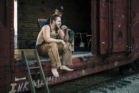 Hobo King Dutch, who first set out to ride the rails when he was 10 years old,  meets up at the festival’s boxcar with Britt resident John Pratt.