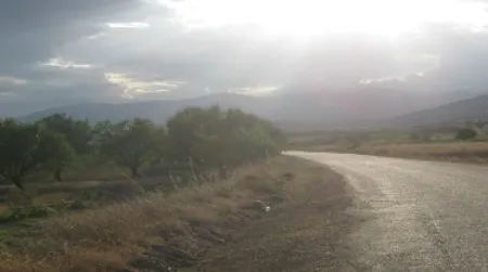 Sunlight bursts through a ceiling of rainclouds above the lonely west shore of Lake Burdur.