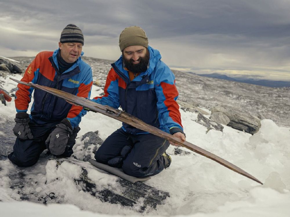 Archaeologists examine the second ski after it was freed from the ice