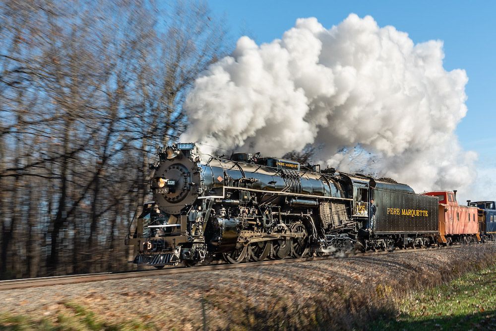 A steam locomotive with smoke billowing
