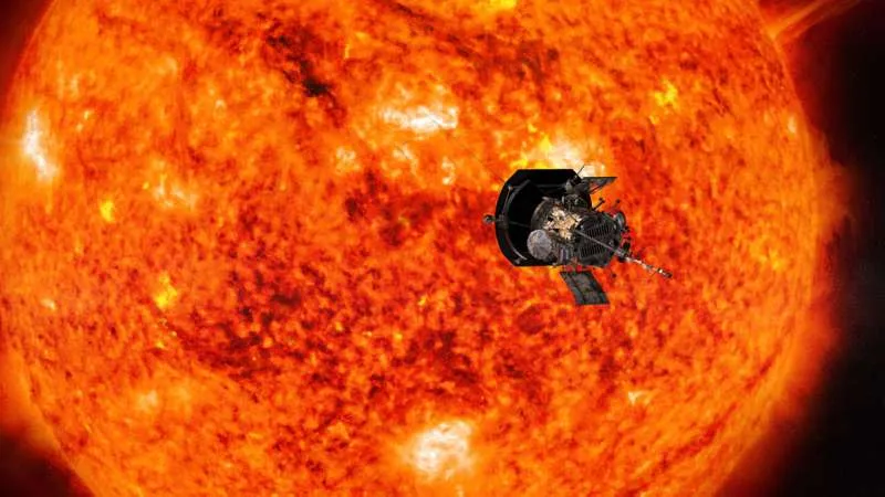 An image of the probe approaching the sun. The sun takes up most of the frame as a glowing, red-orange mass. The probe looks like a small machine approaching its surface.